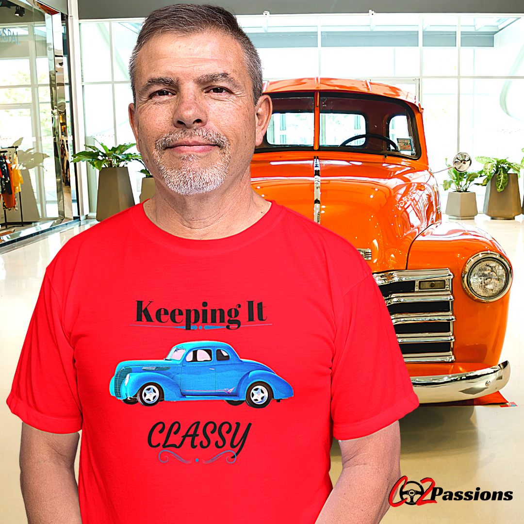 an auto enthusiast wearing co2passions keeping it classy shirt standing in front of his classic vehicle